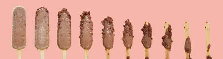 melting process red bean ice cream stick on pink backgroundの写真素材