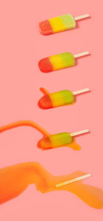 angle view multi-color ice cream melting process on pink backgroundの写真素材