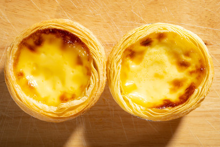 top view two fresh portuguese egg tarts