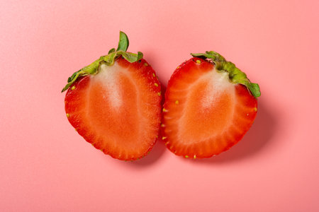 fresh cut out strawberry on pink backgroundの写真素材