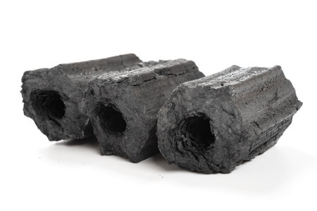 three pieces of charcoal on a white backgroundの写真素材