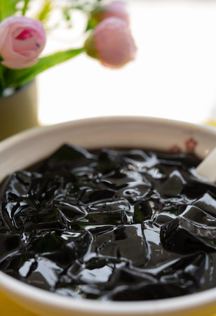 angle view bowl of Licorice black jelly with honey vertical compositionの写真素材