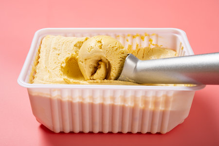 angle view box of ice cream with a spoon at horizontal compositionの写真素材