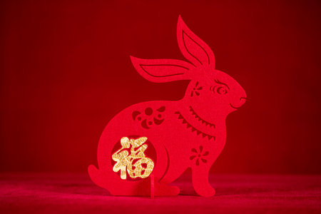 Chinese New Year of Rabbit mascot paper cut on red the Chinese means fortuneの写真素材