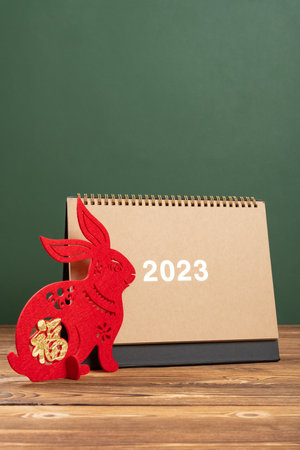 Chinese New Year of Rabbit mascot with 2023 calendar at vertical composition translation of the Chinese is fortuneの写真素材