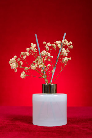 bottle of perfume on red verrtical compositionの写真素材