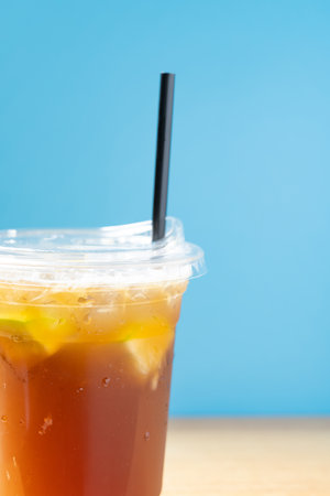 side view cup of iced lemon with straw vertical compositionの写真素材