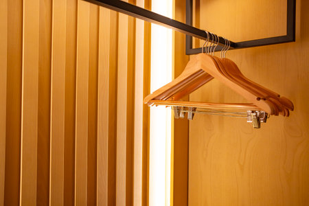 hangers in a wooden wardrobeの写真素材