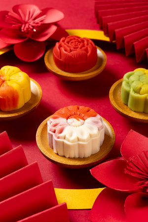angle view trendy different flower shapes mooncakes surrounded by traditional Chinese style decorations at vetical compositionの写真素材