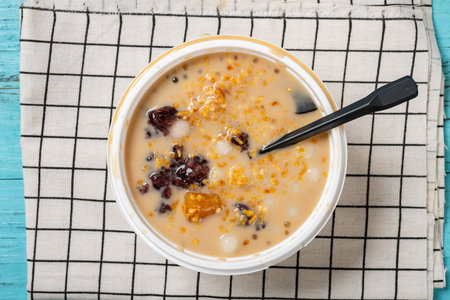 top view bowl of milktea flavor syrup mixed with grass jelly and mangoes and peach gum and tapiocas and red beans and guiling jelly etc. at horizontal compositionの写真素材