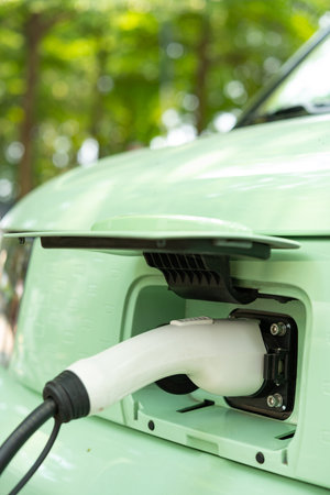 an electrical car being charged vertical compositionの写真素材