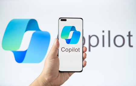 ZHONGSHAN China-October 10,2023:hand holding a mobile with Copilot logo at horizontal composition.のeditorial素材