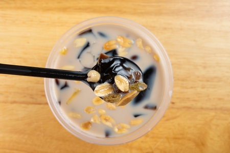 top view bowl syrup mixed with grass jelly and mangoes and peanuts and tapiocas and guiling jelly etc. at horizontal compositionの写真素材