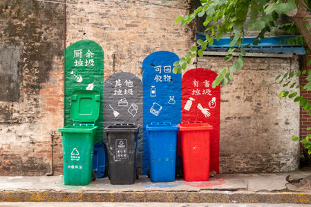 ZHONGSHAN GUANGDONG China-December 4 2023:different colors litter bins for garbage sorting at horizontal composition.のeditorial素材