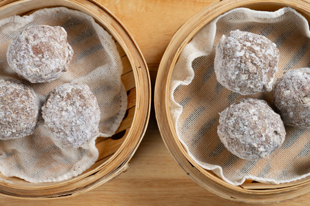 top view raw frozen beef balls in bamboo steamers