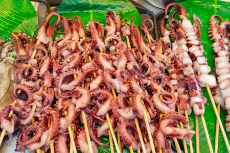 top view skewers of raw squid ready to be grilledの写真素材
