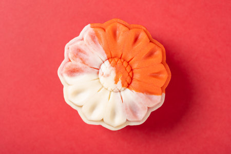 top view flower shape white and red mooncake on red