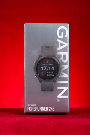 ZHONGSHAN China-December 6,2023:brand new Garmin Forerunner 245 sports watch at vertical composition.のeditorial素材