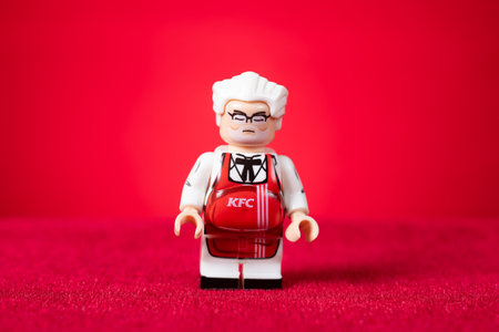 Zhongshan China-September 7 2024:Kentucky Fried Chicken grandpa figurines on red background.