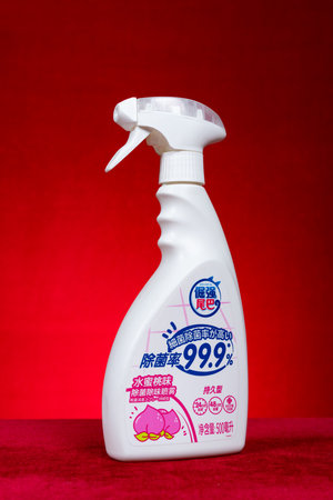 ZhongShan China-January 27,2023:bottle of disinfecting solution on red background at vertical composition.のeditorial素材