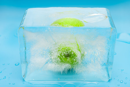 green apple in a frozen ice blockの写真素材