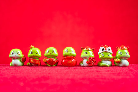 Chinese New Year of Snake mascots on red translation of the Chinese characters are attract wealth and treasures no logo no trademarkの写真素材