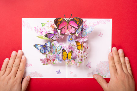 a pink 3D gift card with lots of beautiful butterfliesの写真素材