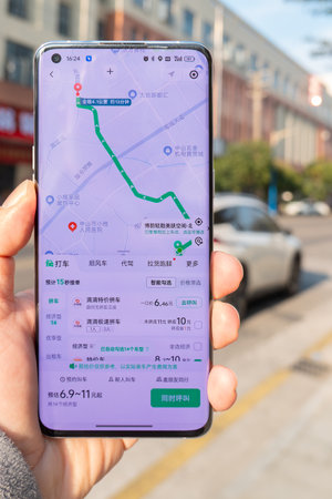 ZHONGSHAN China-December 21,2024:hand holding a mobile and calling taxi at vertical composition.