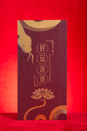 red pocket for Chinese New Year of the Snake on red background translation of the Chinese characters are good luck all the way no logo no trademarkの写真素材