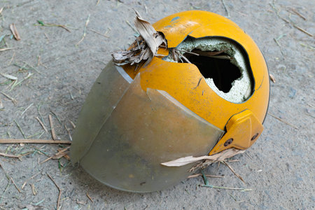 broken motobike helmet on the floorの写真素材