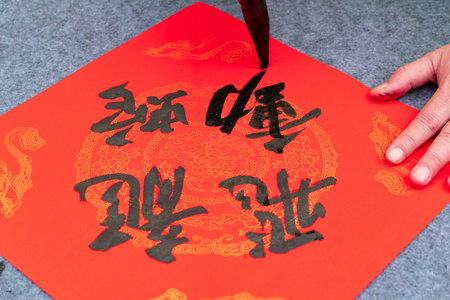 writing Chinese new year scrolls translation of the characters are dragons flying and snakes movingの写真素材