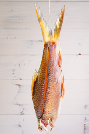 raw crucian carp being air dried at vertical compositon