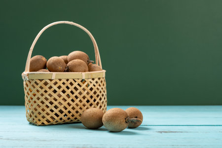 angle view Achras zapota or sapota or Manilkara zapota and a basketの写真素材