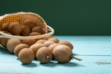 angle view Achras zapota or sapota or Manilkara zapota and a basketの写真素材