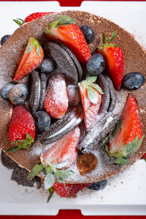 top view birthday cake with fruits and crackers at vertical compositionの写真素材