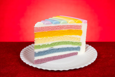 rainbow colors cake on a red background at horizontal composition