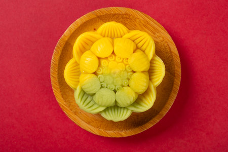 top view flower shape yellow mooncake on red