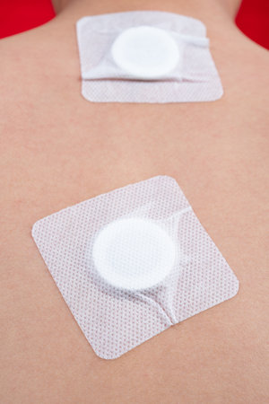 a boy with a cough-relief acupressure patches on his back