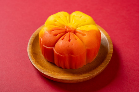 angle view flower shape orange mooncake on red