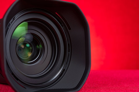 a camera lens on a red background at horizontal composition