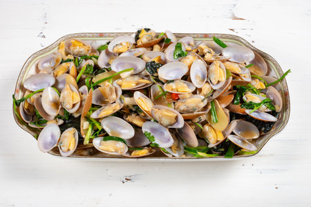angle view dish of fresh homemade stir-fried clams at horizontal compositionの写真素材