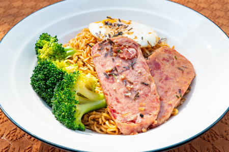 angle view instant noodles with luncheon meat and fried egg at horizontal compositionの写真素材
