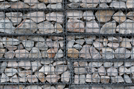 wall made by wire mesh cages  with stones at horizontal composition