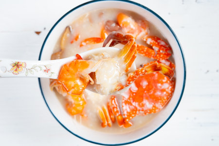 top view fresh seafood porridge with shrimps and crabs at horizontal compositionの写真素材
