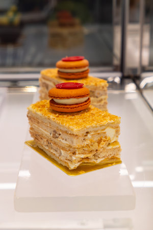 elegant layered pastries topped with colorful macaroonの写真素材