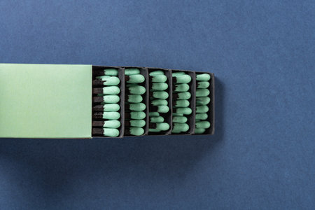 top view green matchboxes on a blue background at horizontal compositionの写真素材