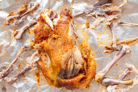 top view half eaten torn roasted chickenの写真素材