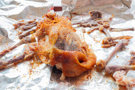 angle view half eaten torn roasted chickenの写真素材