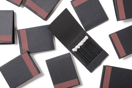 top view paper packages black match sticks on white at horizontal compositionの写真素材