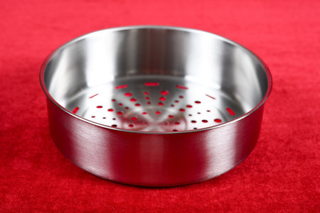 angle view stainless steel steamer on red backgroundの写真素材